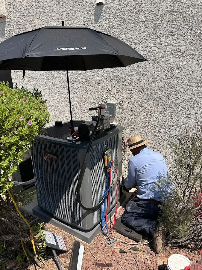 HVAC technician performing outdoor AC maintenance in Galesburg